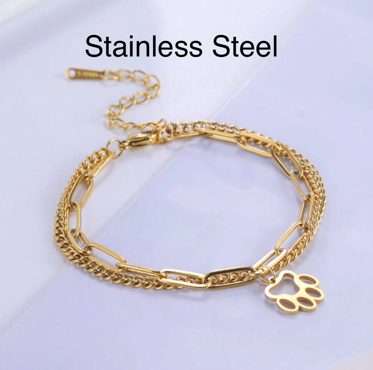 Pulsera de doble cadena en dorado de acero inoxidable con dije de huellita